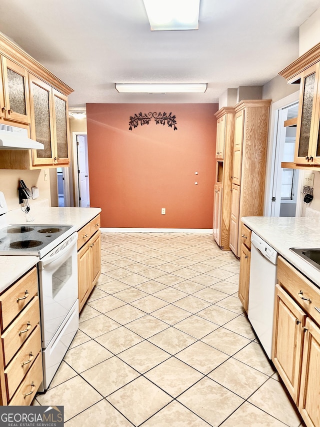 kitchen featuring white appliances, light tile patterned flooring, and light brown cabinetry