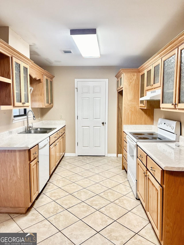 kitchen with sink, white appliances, and light tile patterned floors