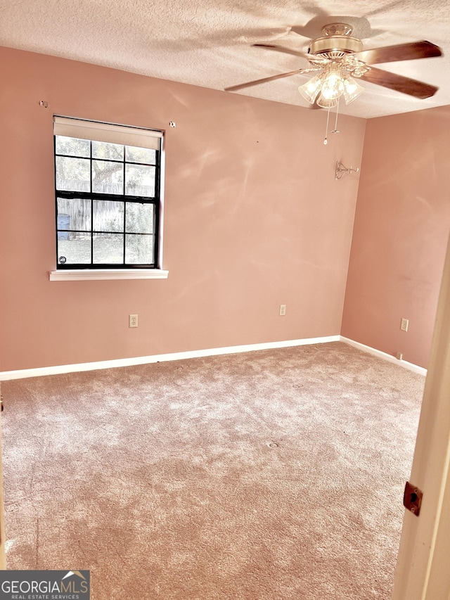 carpeted empty room featuring a textured ceiling and ceiling fan