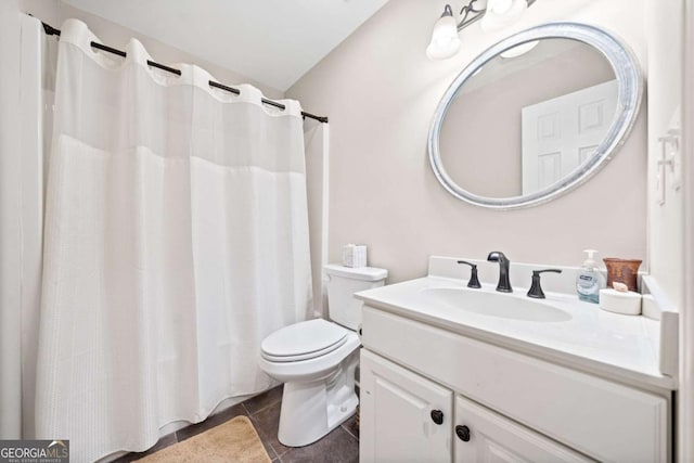 bathroom featuring tile patterned flooring, vanity, and toilet