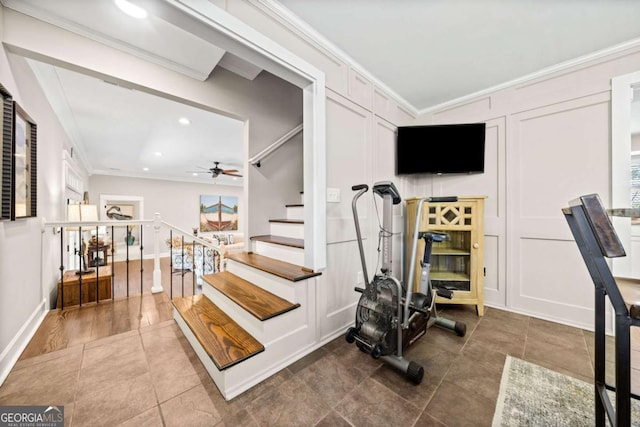 workout area with ceiling fan, ornamental molding, and tile patterned floors