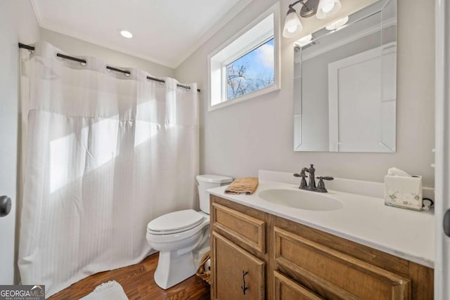 bathroom with toilet, wood-type flooring, vanity, and crown molding