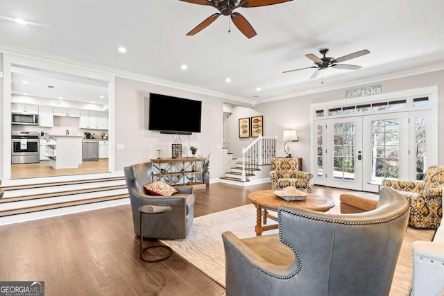 living room featuring french doors, light hardwood / wood-style floors, and crown molding