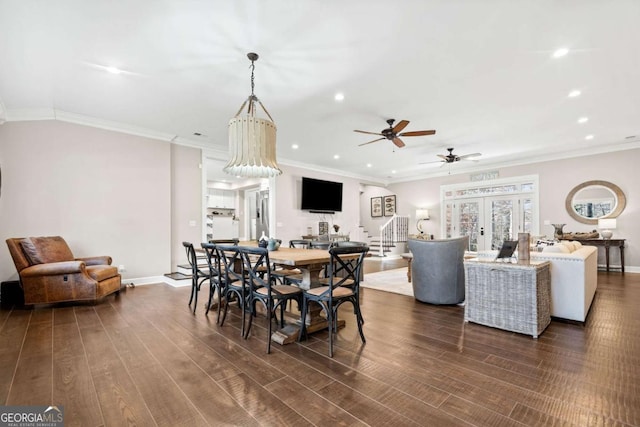 dining room with french doors, ceiling fan, crown molding, and dark wood-type flooring