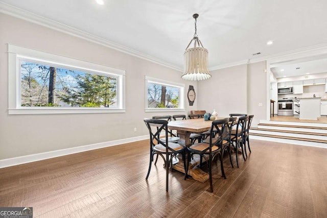 dining space with crown molding and dark hardwood / wood-style floors