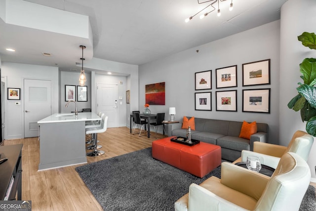 living room with sink and light hardwood / wood-style flooring