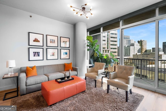 living room featuring floor to ceiling windows, a chandelier, and hardwood / wood-style floors