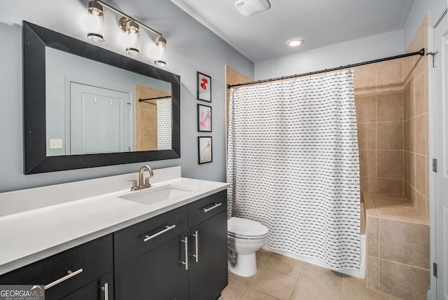 bathroom featuring toilet, vanity, tile patterned floors, and a shower with curtain