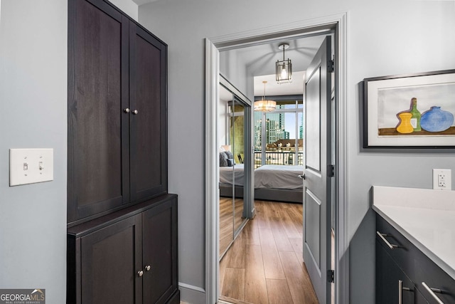 hallway with hardwood / wood-style floors