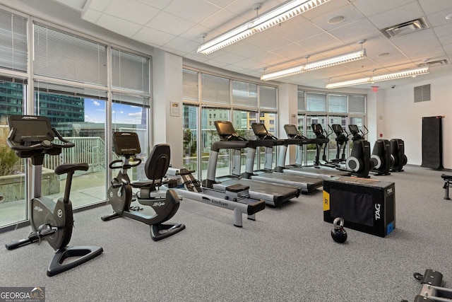 gym with a paneled ceiling