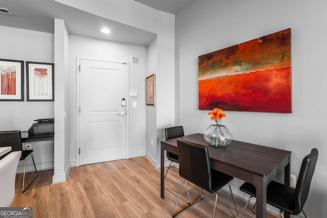 dining space with light hardwood / wood-style flooring