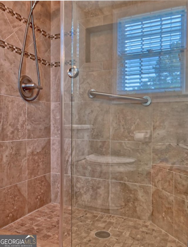 bathroom with tiled shower