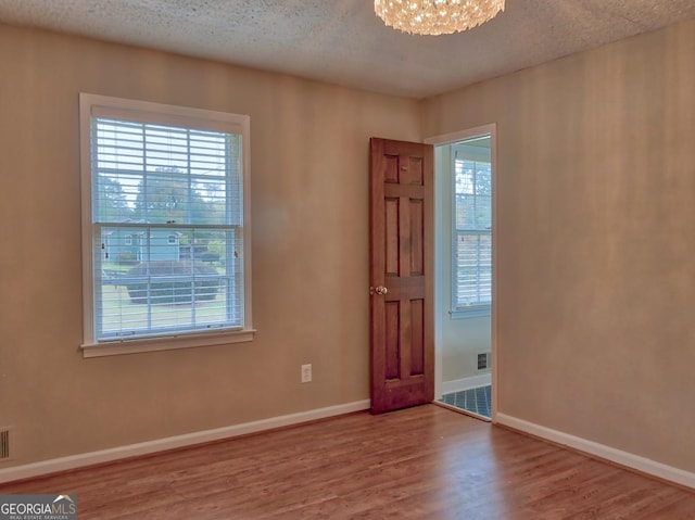 interior space with a notable chandelier and hardwood / wood-style flooring