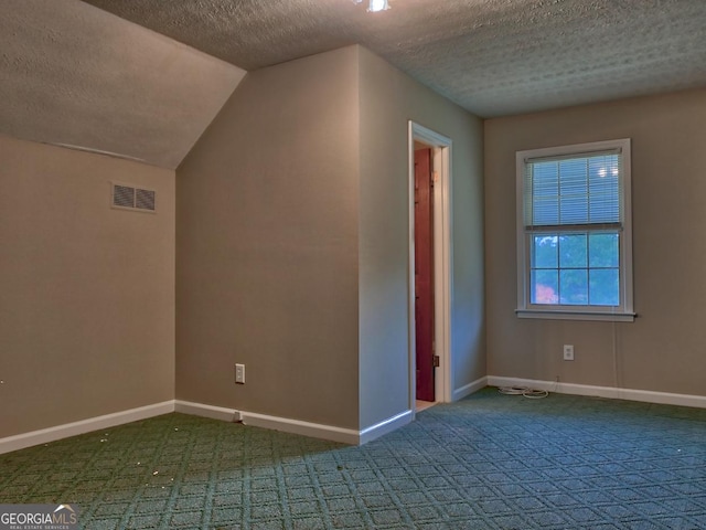 bonus room featuring a textured ceiling, lofted ceiling, and carpet