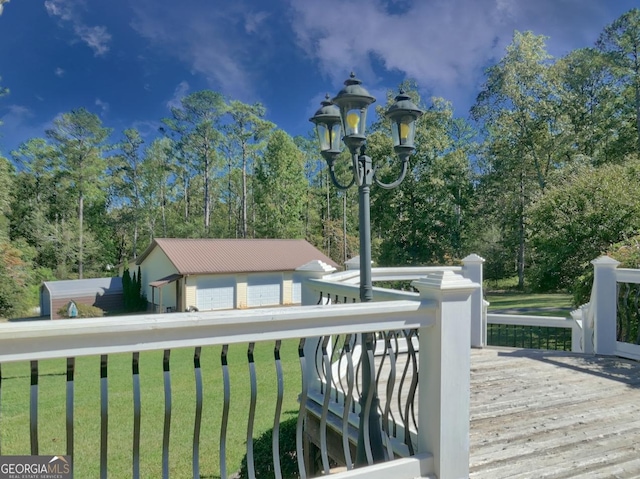 exterior space with a deck, a yard, and an outbuilding