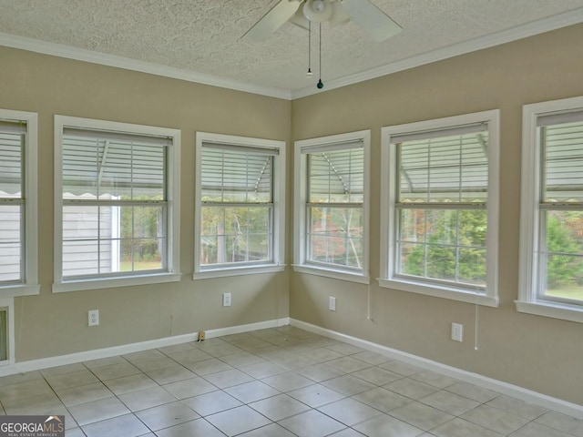 unfurnished sunroom with ceiling fan