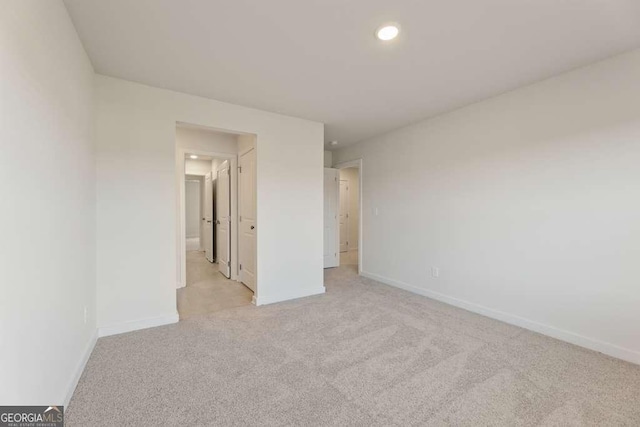 unfurnished bedroom with light colored carpet