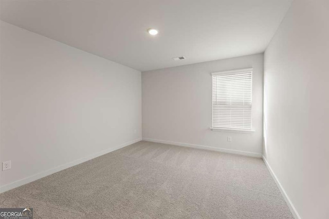 spare room with light colored carpet