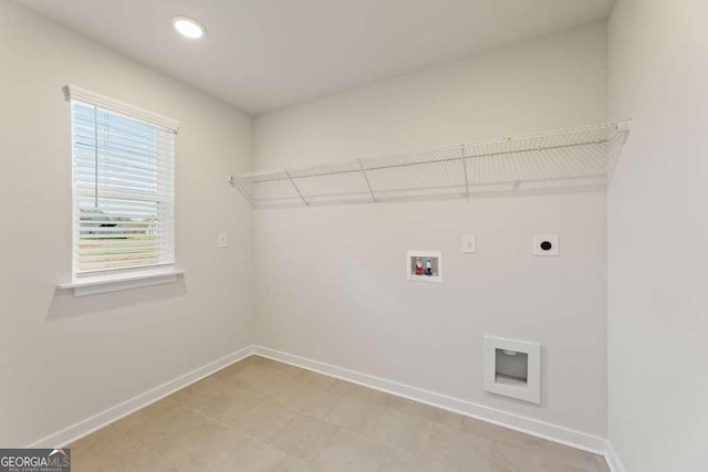 clothes washing area with electric dryer hookup and washer hookup