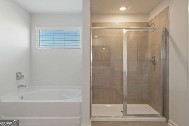 bathroom featuring independent shower and bath