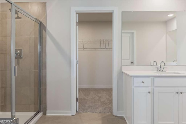 bathroom with a shower with door and vanity