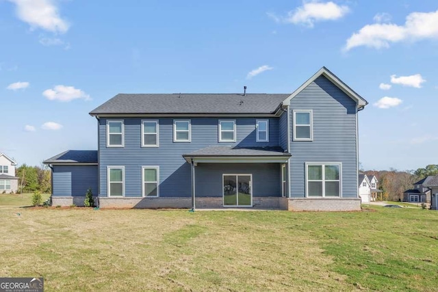 rear view of property with a yard