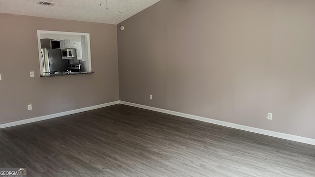 empty room featuring dark wood-type flooring