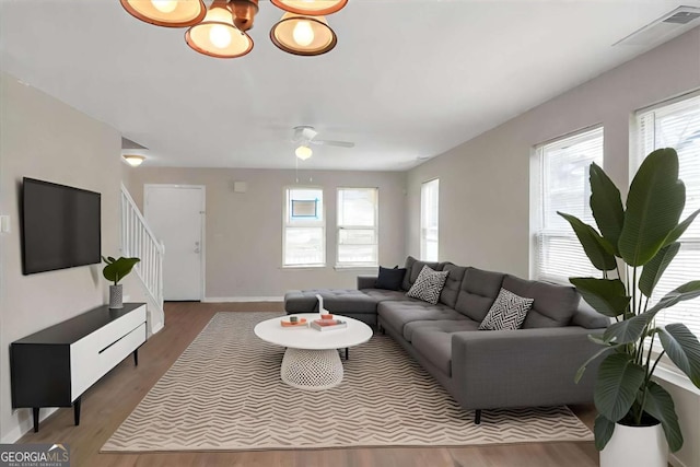 living room featuring ceiling fan and wood-type flooring