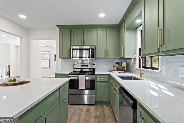 kitchen with sink, stainless steel appliances, and green cabinetry