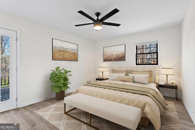 bedroom featuring access to exterior, ceiling fan, and light hardwood / wood-style floors