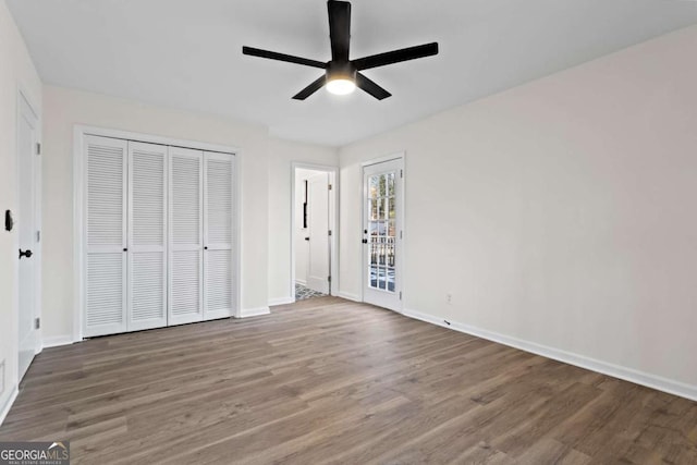 unfurnished bedroom with ceiling fan and wood-type flooring