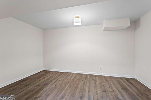 unfurnished room featuring dark wood-type flooring