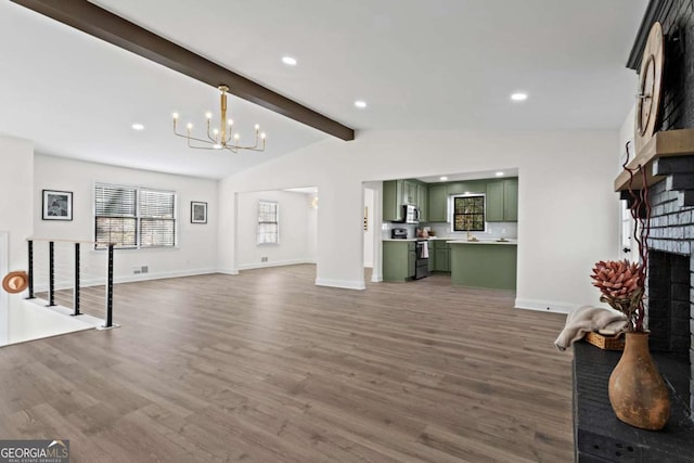 living room with a notable chandelier, a brick fireplace, lofted ceiling with beams, and dark hardwood / wood-style floors