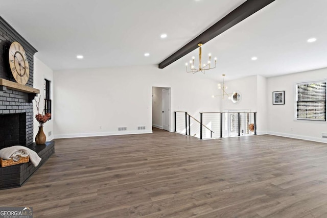 unfurnished living room featuring a brick fireplace, a notable chandelier, dark hardwood / wood-style flooring, and vaulted ceiling with beams