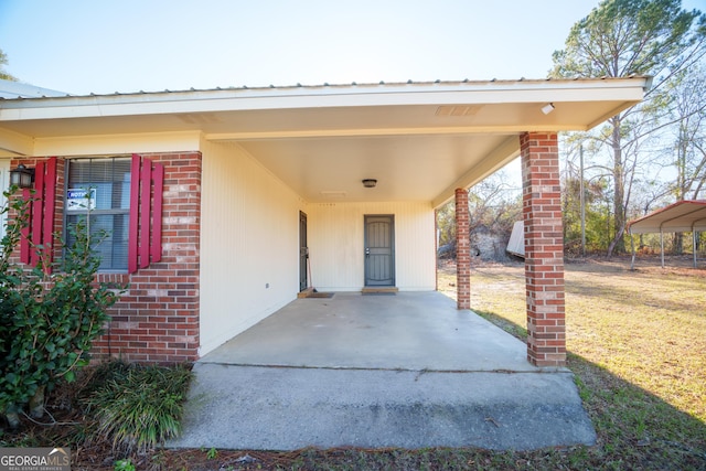 property entrance with a carport