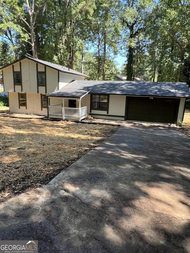 view of front of home featuring covered porch and a garage