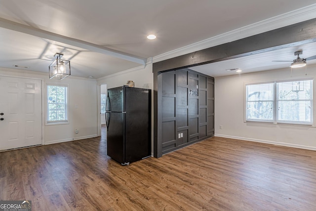 kitchen with black fridge, ceiling fan, crown molding, and wood-type flooring