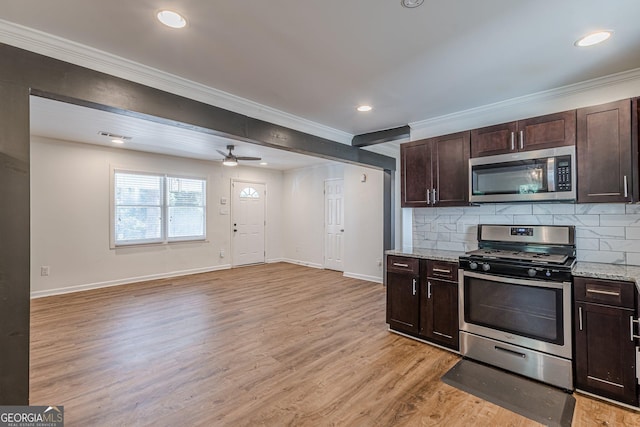 kitchen featuring appliances with stainless steel finishes, backsplash, light stone counters, and dark brown cabinetry