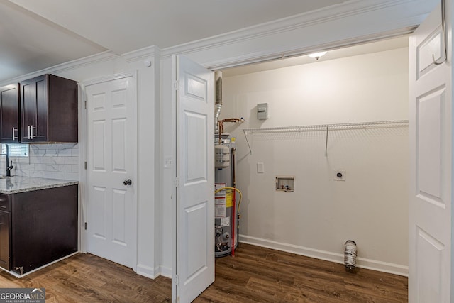 clothes washing area with gas water heater, electric dryer hookup, crown molding, dark hardwood / wood-style flooring, and washer hookup