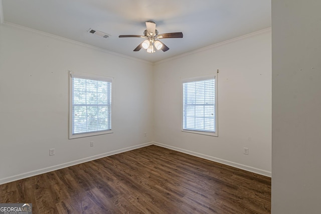 empty room featuring dark wood-type flooring, ceiling fan, crown molding, and a wealth of natural light