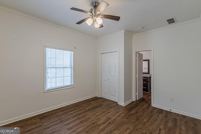 unfurnished bedroom with a closet, ornamental molding, ceiling fan, and dark hardwood / wood-style flooring