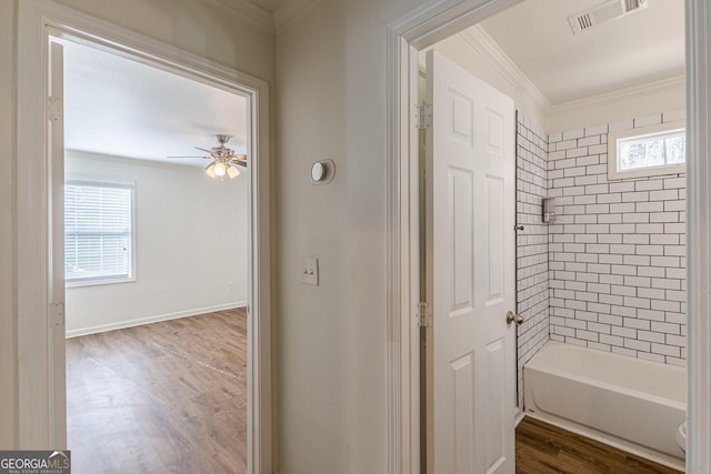 bathroom with toilet, shower with separate bathtub, hardwood / wood-style floors, ornamental molding, and ceiling fan