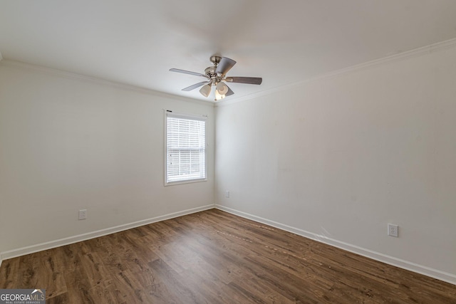 spare room with ornamental molding, dark wood-type flooring, and ceiling fan