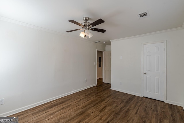 spare room with ornamental molding, ceiling fan, and dark wood-type flooring