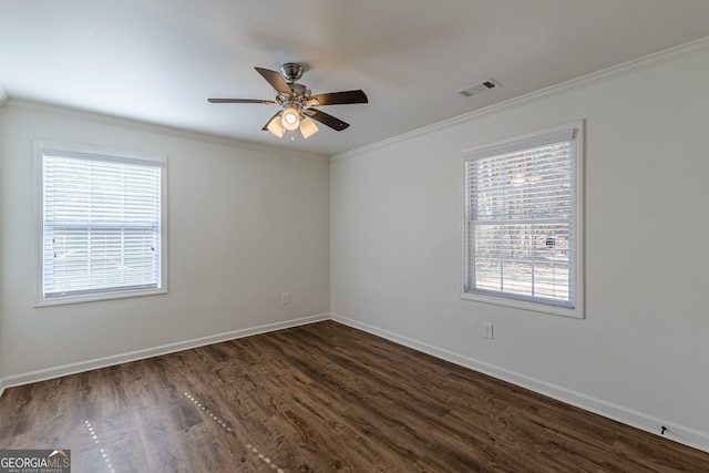 empty room with ceiling fan, ornamental molding, and dark hardwood / wood-style floors