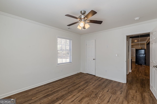 unfurnished room featuring ornamental molding, ceiling fan, and dark hardwood / wood-style floors