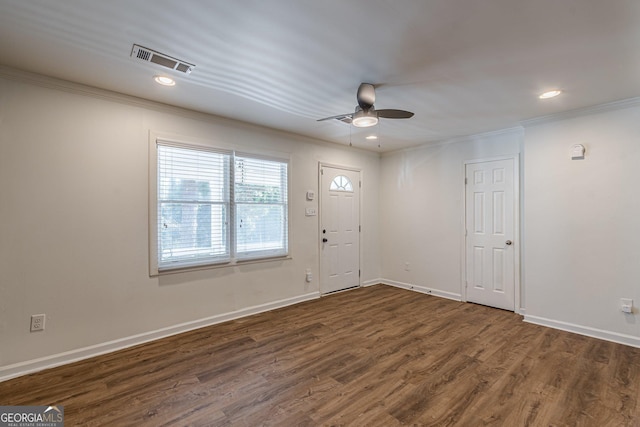 empty room with ceiling fan, dark wood-type flooring, and crown molding