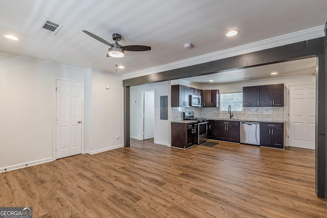 kitchen with sink, stainless steel appliances, tasteful backsplash, ceiling fan, and dark brown cabinetry