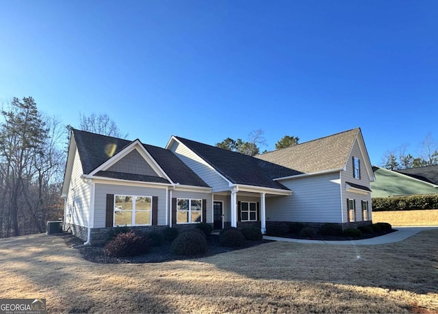 view of front of home with a front yard and central AC unit