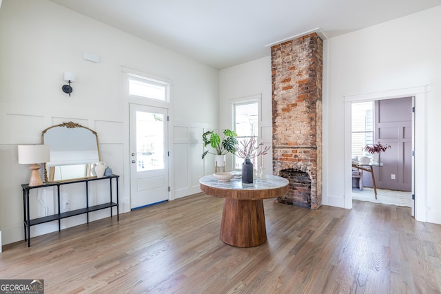 entryway featuring hardwood / wood-style floors and a fireplace